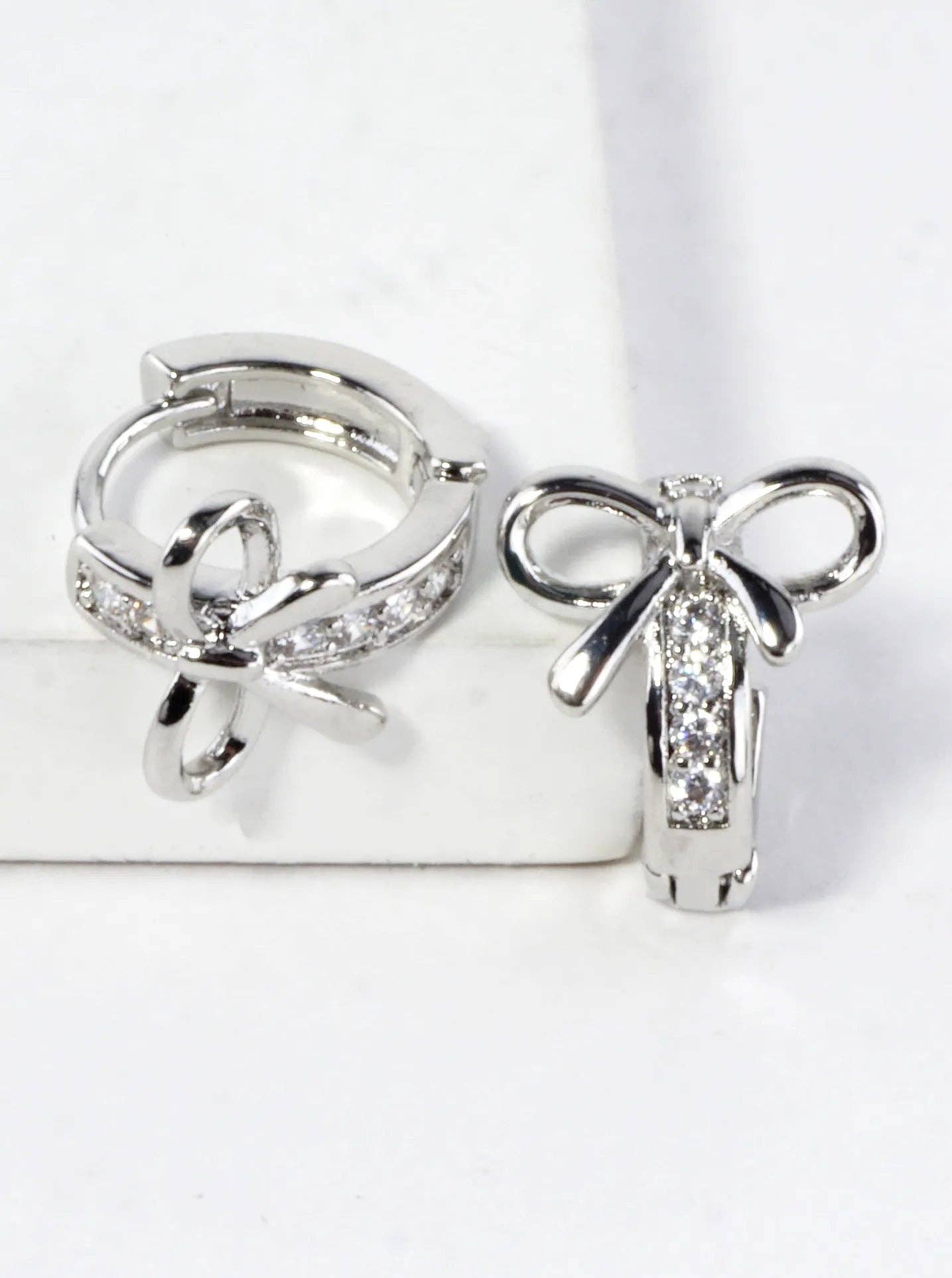 CZ Pave Polished Ribbon Bow Huggie Hoop Earrings: Rhodium Clear